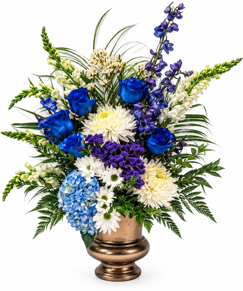 Arrangement floral funéraire Paix Boréale composé de roses bleues, d'hortensias, de marguerites blanches, de chrysanthèmes et de fleurs mauves dans un vase foncé.
