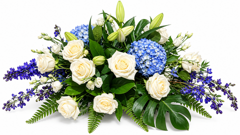Coussin de cercueil Bleu Sérénité composé de roses blanches, d'hortensias bleus, de lys en bouton, de fleurs violettes et de feuillage tropical.