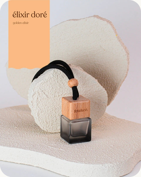 Diffuseur pour voiture Élixir doré en verre noir mat, parfum coco, vanille, ambre et musc