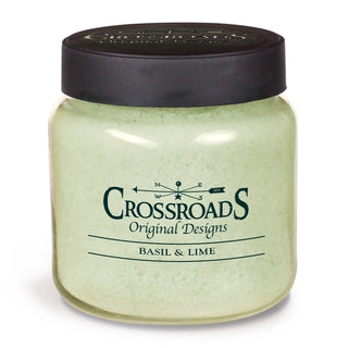 Bougie parfumée Crossroads Original Designs au basilic et lime dans un pot vert pâle avec couvercle noir.