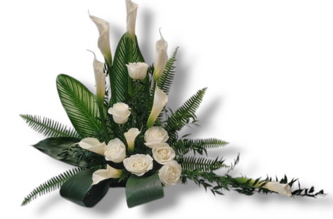 Arrangement funéraire avec callas et roses blanches, feuillage vert et style asymétrique – modèle Pureté Éternelle.