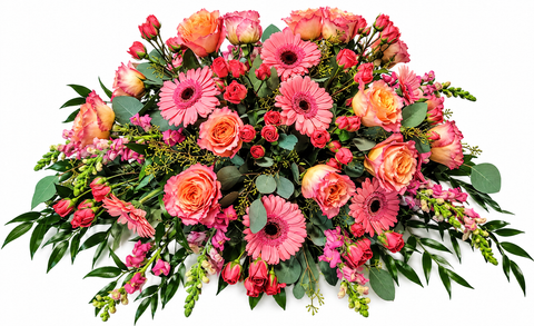 Coussin de cercueil aux tons de rose et de corail composé de roses, gerberas, mini-roses, mufliers et feuillage luxuriant.