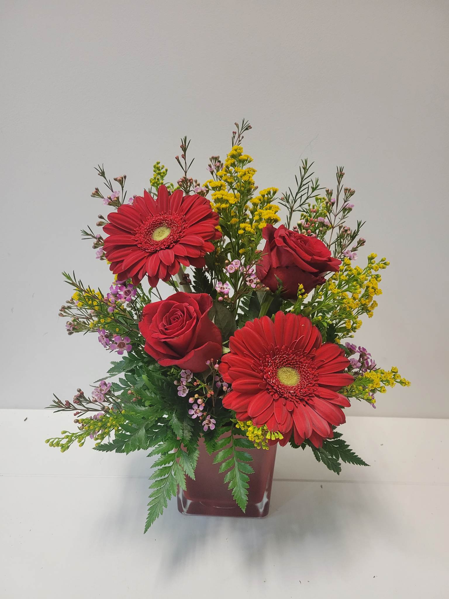 Gerberas et roses rouges dans un vase